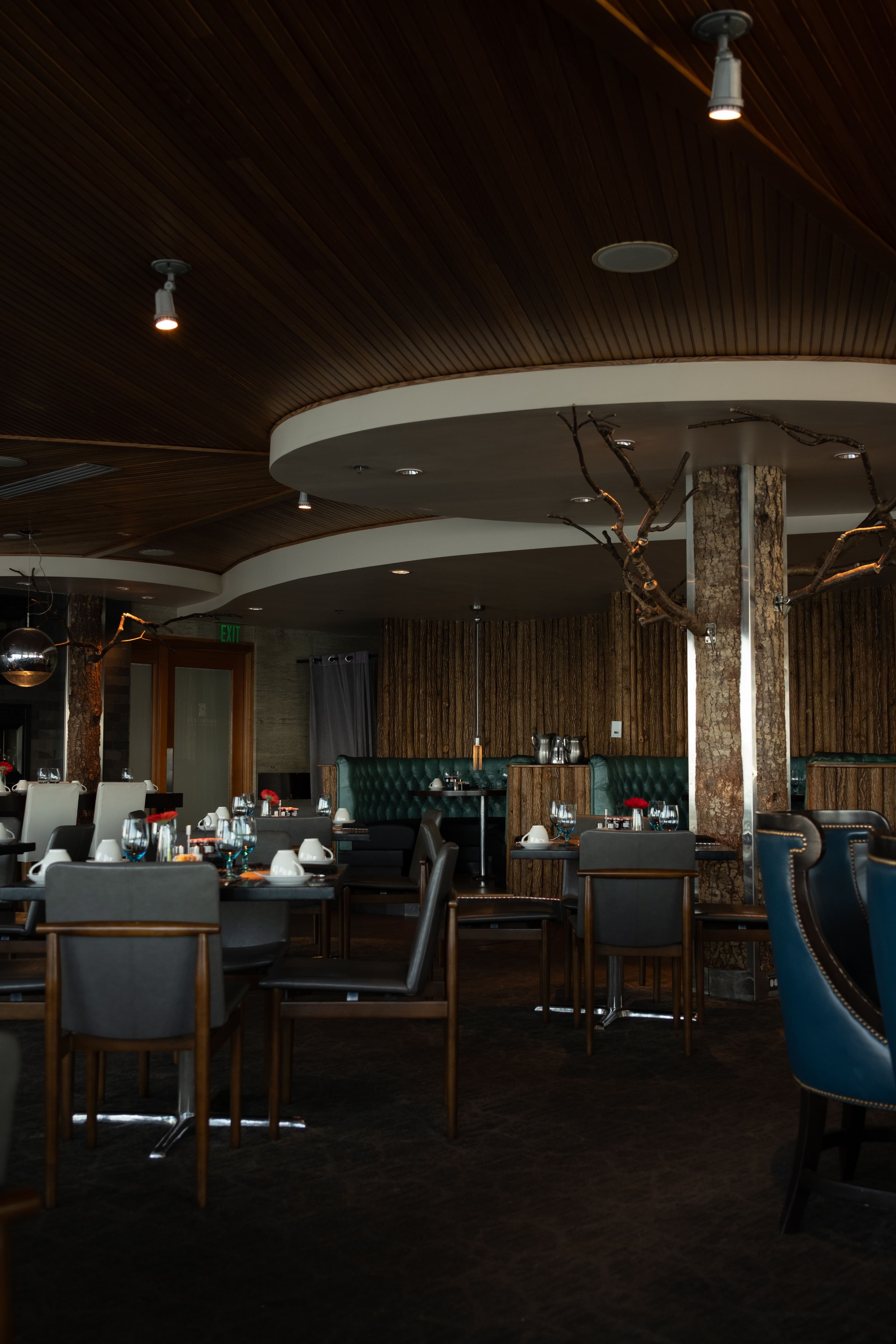 Warmly lit dining room with wood-paneled booths