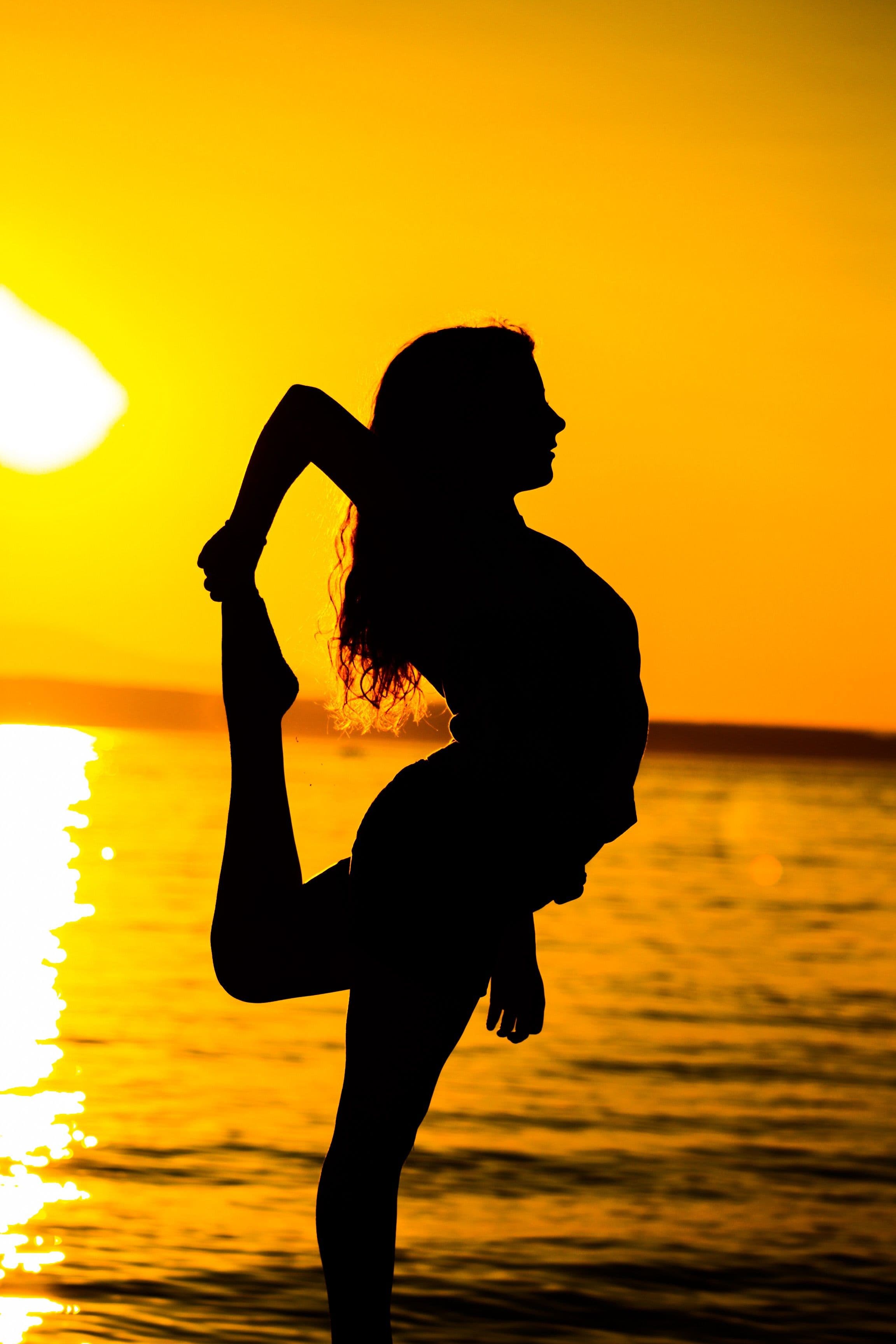 Yoga studio silhouetted against a sunset